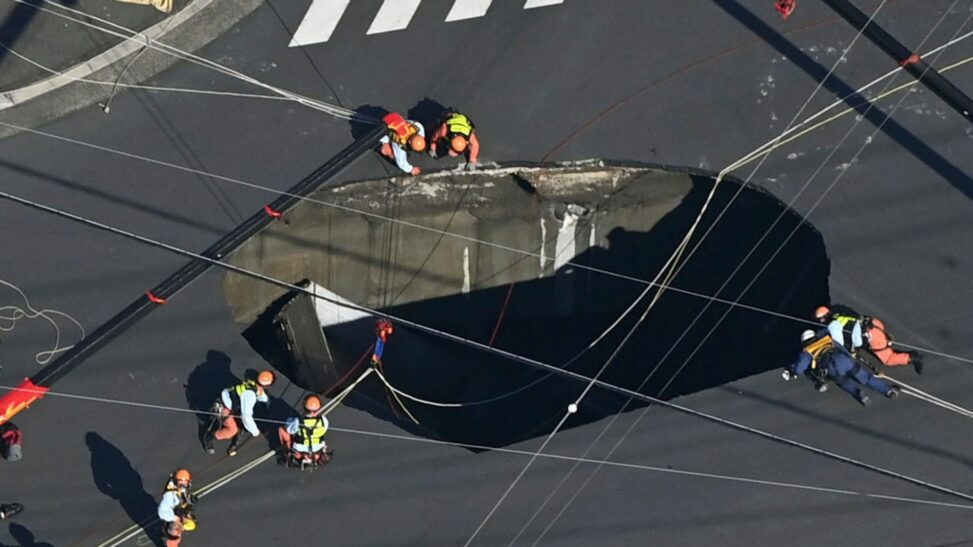 Swimming Pool Sized Sinkhole Swallows Truck On Busy Road, Trapping Driver