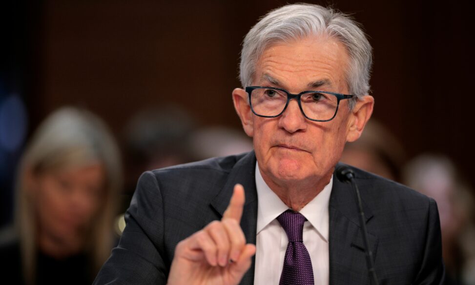 Fed holds rates steady, cuts growth outlook, raises inflation forecast