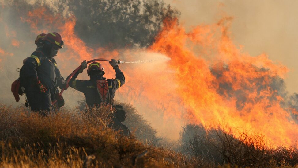 Wildfire tears through part of greek island forcing hundreds to flee homes and hotels