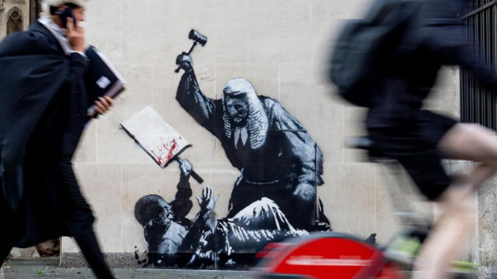 New banksy artwork appears on court building showing judge attacking protester