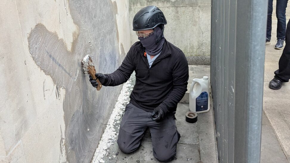 New banksy artwork being scrubbed off royal courts of justice wall