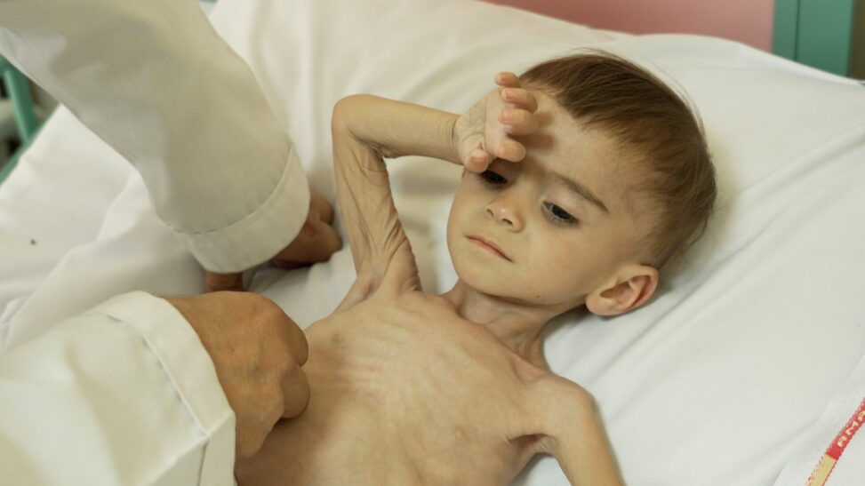 Crying babies dimmed by hunger fill this hospital where parents fear each day might be the last