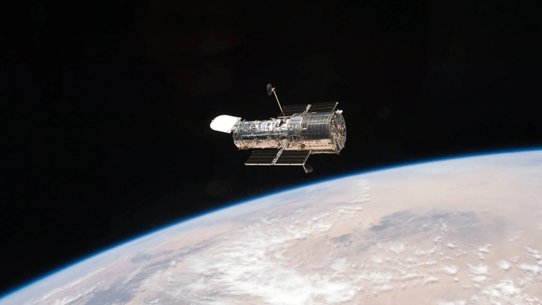 A figure eight in deep space: hubble image shows gravity warping distant galaxies